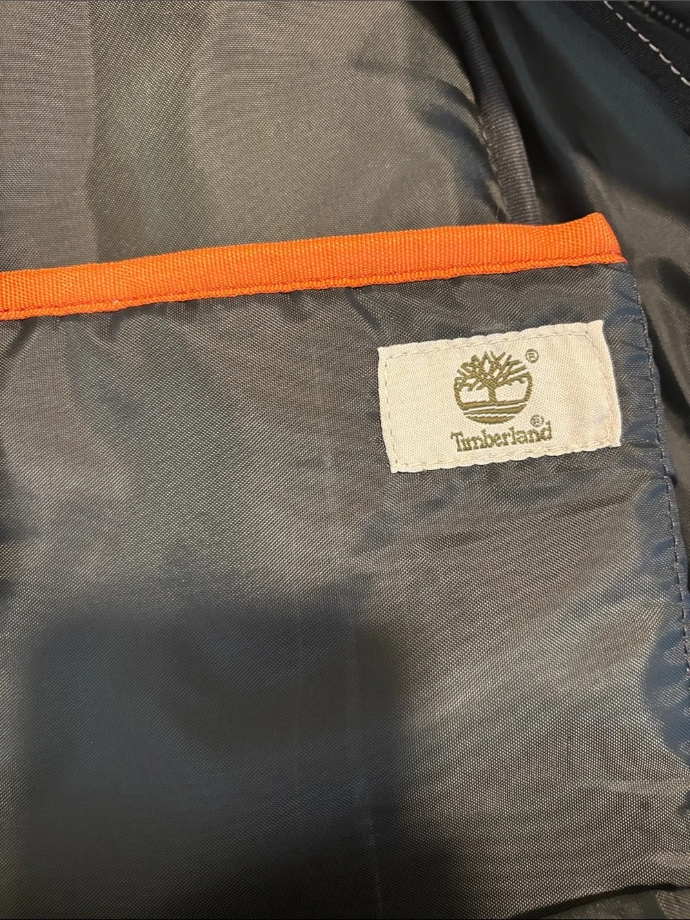 Timberland Black Canvas Backpack with Brown Trim and Orange Pull
